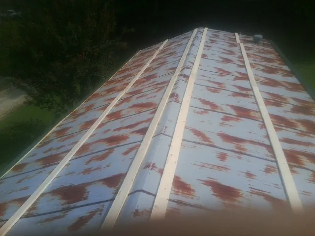 Rusted metal roof panels with new wood purlins before replacement — Storm Damage Roof Repair in Buckeystown by Roofing Brothers