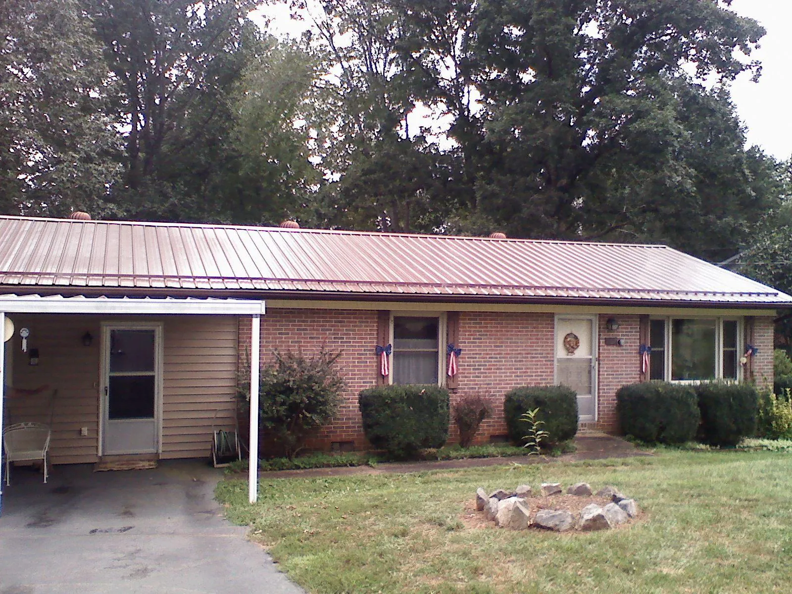 Bronze metal roof and carport on a brick ranch home — Roof Repair work by our crew in Buckeystown