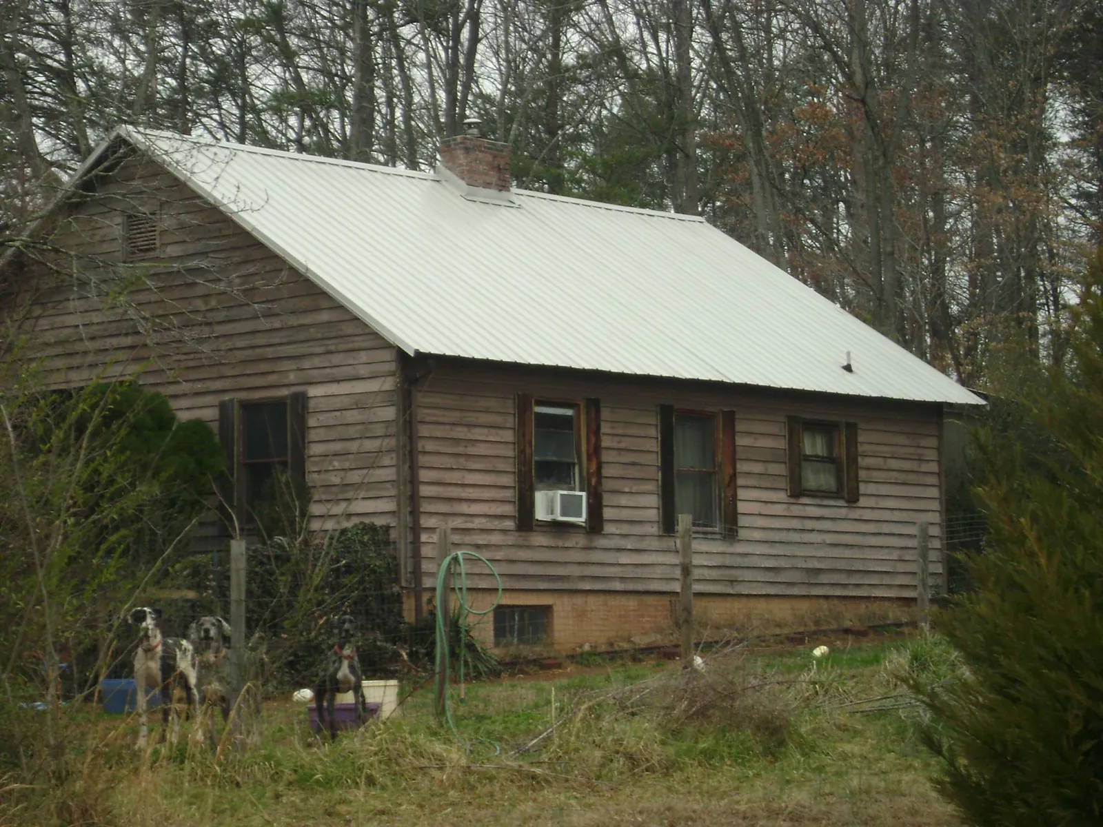 White metal roof on an old wood sided farmhouse, from a Metal Roof Installation job in Buckeystown